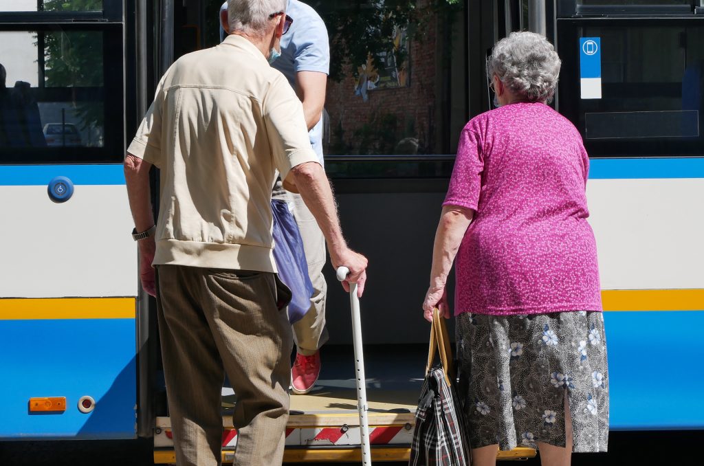 Old people are getting on the bus